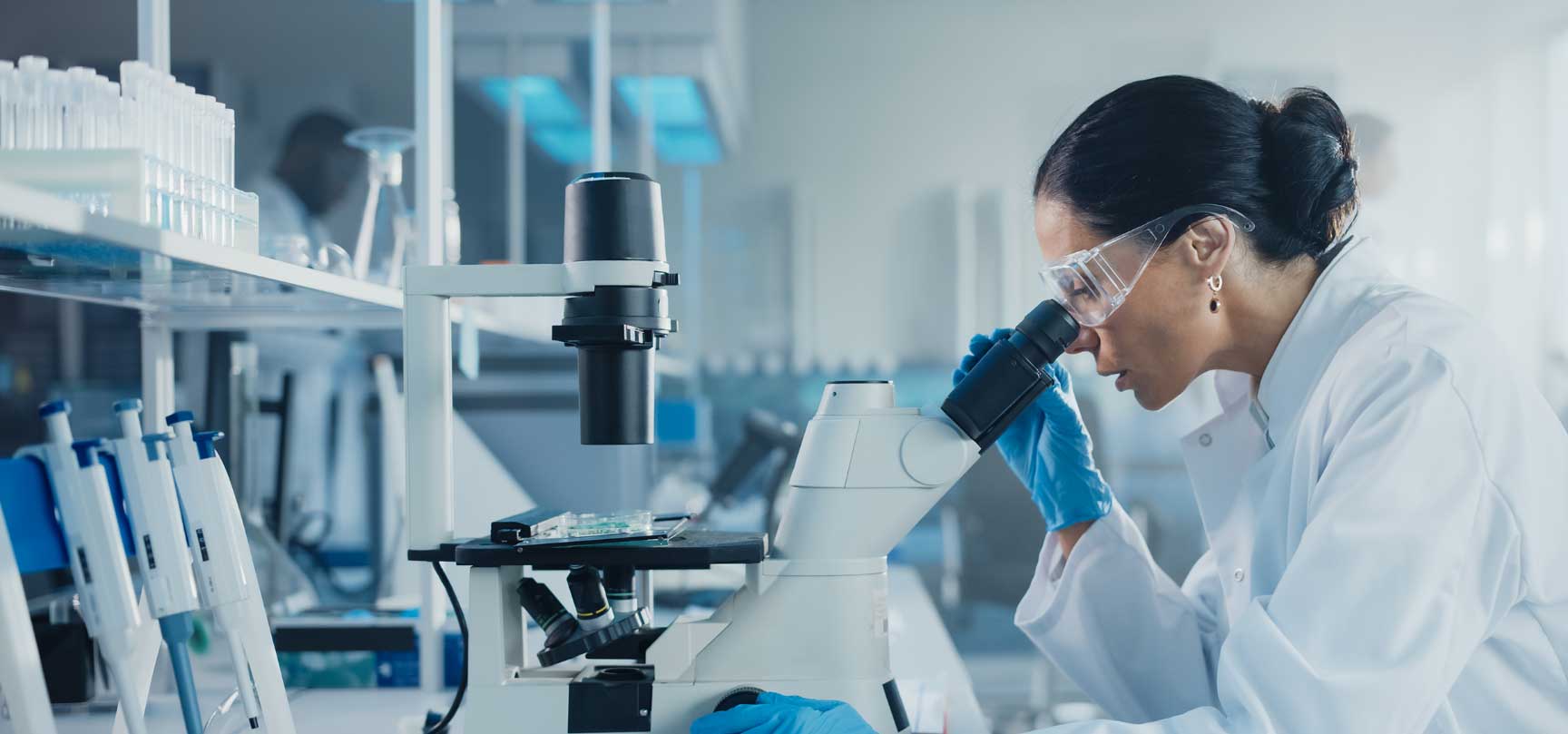 Scientist looking into microscope in a modern laboratory